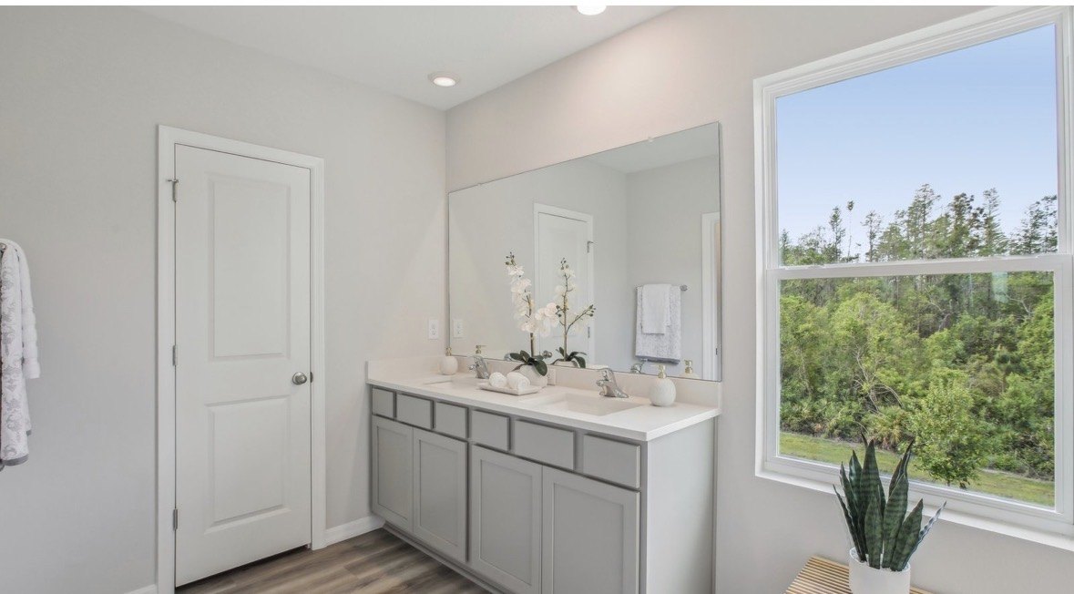 Bright bathroom with double sinks and window